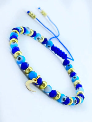 Pulsera con Ojo turco Cristales y checas doradas hecho a mano con dije en forma de Luna good luck