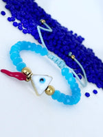 Pulsera con Ojo Turco Triangular Cachito de Coral y Balines dorados good luck