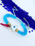 Pulsera con Ojo Turco Triangular Cachito de Coral y Balines dorados good luck